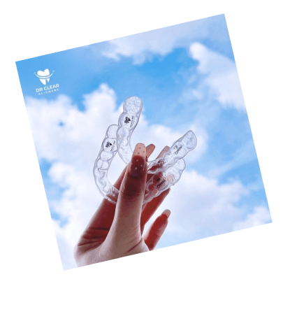Lady Finger Holding Clear Aligners Invisible Braces to The Sky